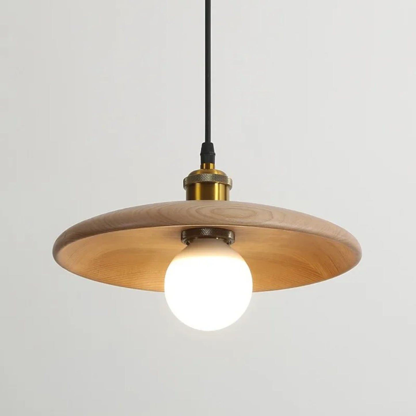Wooden pendant light with a white bulb on a gray background