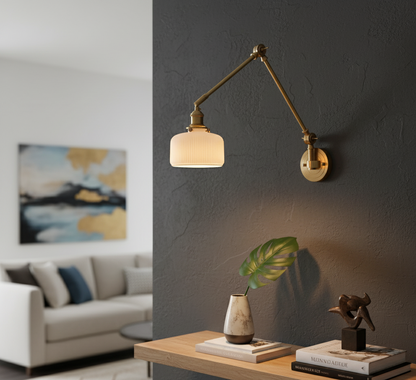 Modern wall sconce in a living room setting with a sofa and decor items.