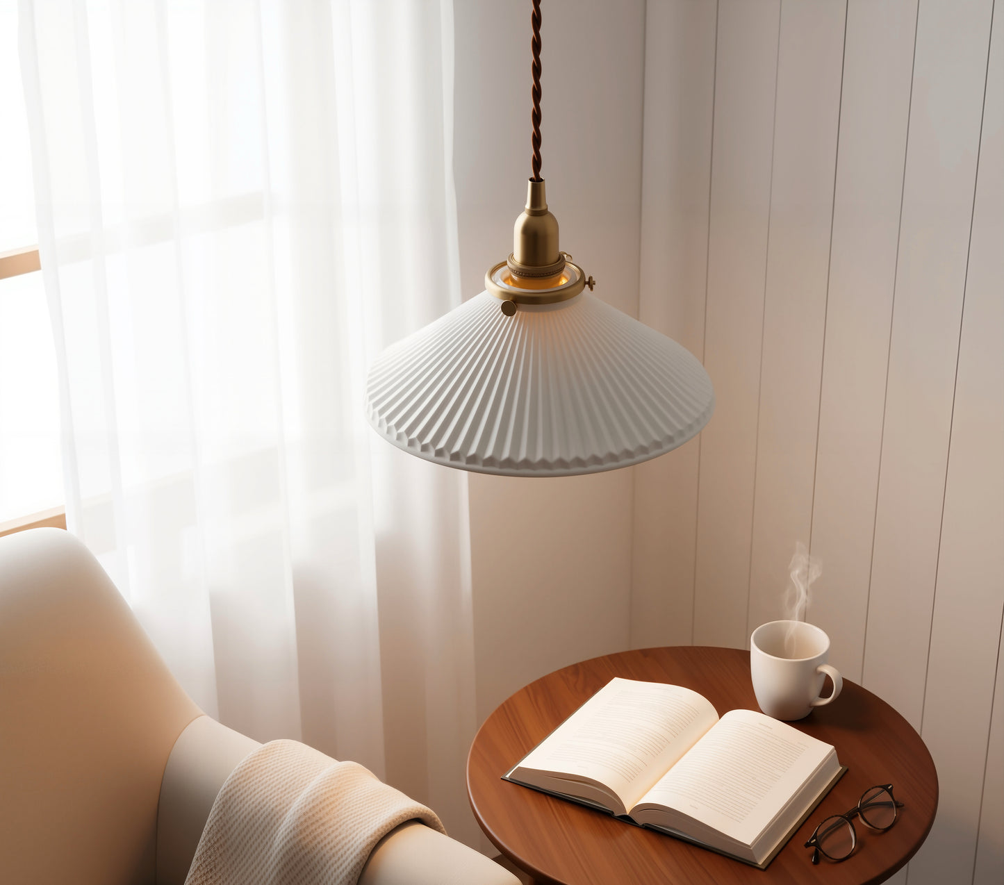 Pendant light over a wooden table with an open book and a cup of coffee.