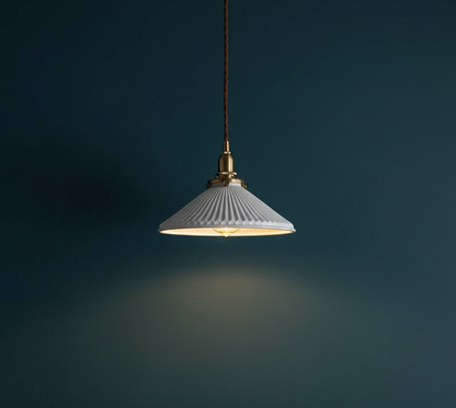 Pendant light with ribbed shade on a dark background