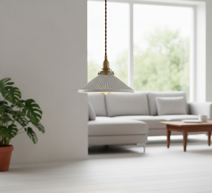 Modern living room with a gray sofa, wooden coffee table, and pendant light.