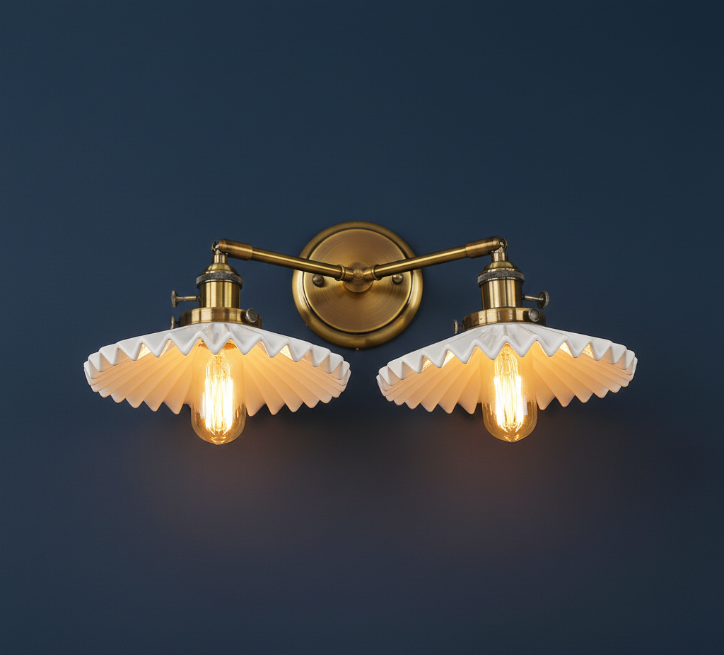 Pair of wall-mounted lights with gold fixtures and white glass shades on a dark blue background.