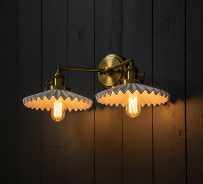Wall-mounted light fixture with ruffled glass shades on a dark wooden background