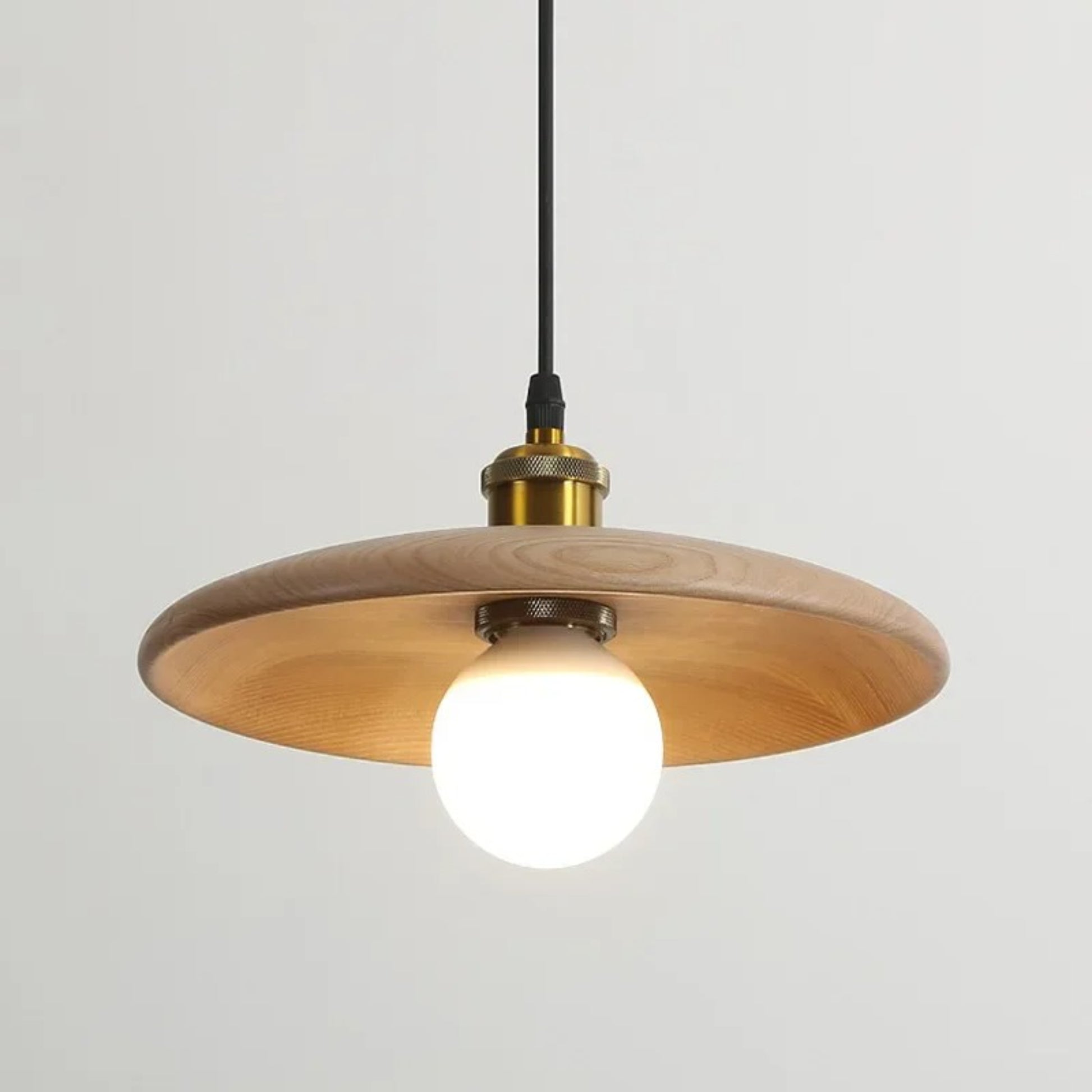 Wooden pendant light with a white bulb on a gray background