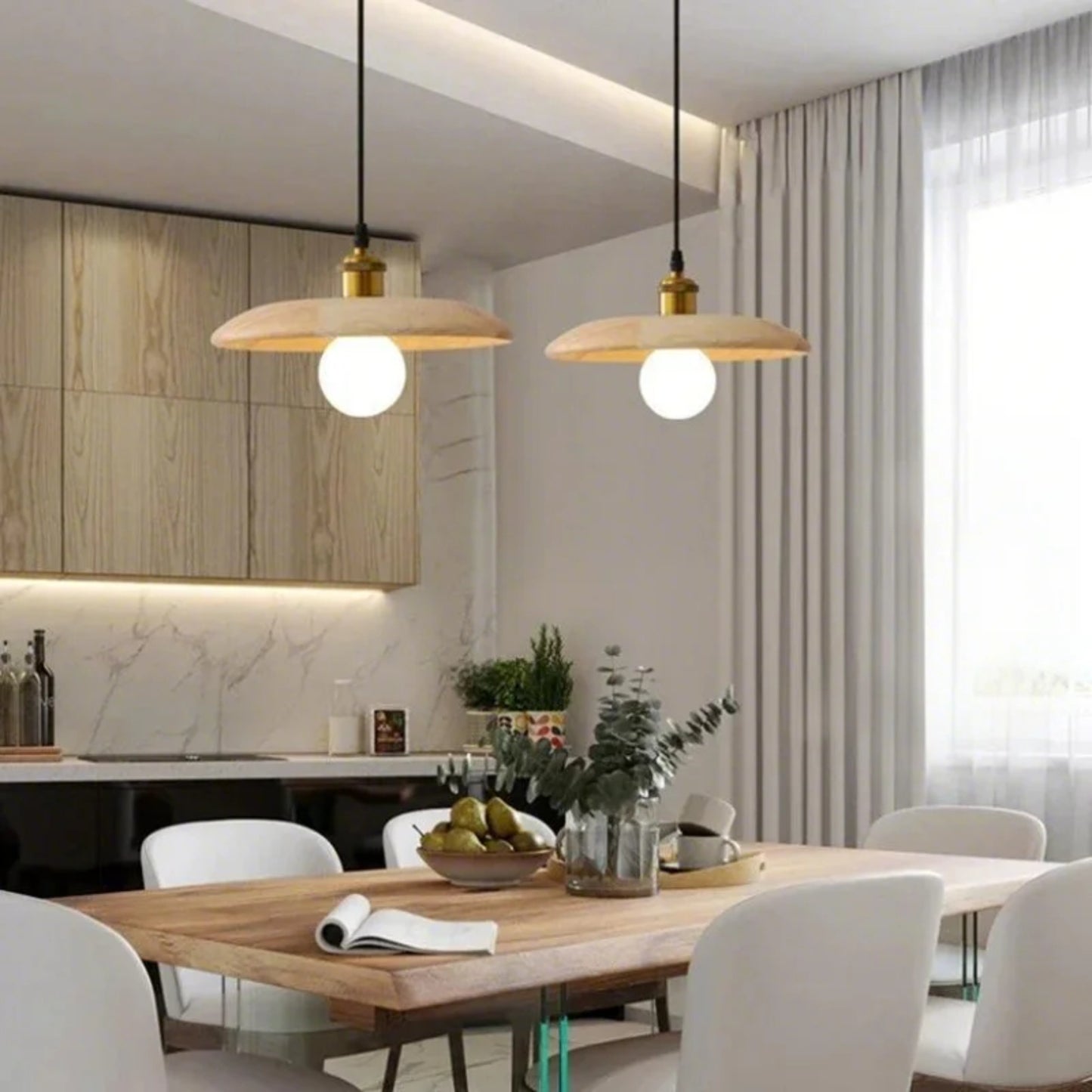 Modern kitchen with wooden table, pendant lights, and white chairs.