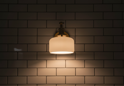 Light fixture on a tiled wall casting a warm glow