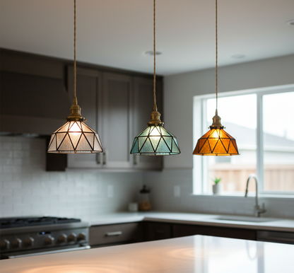 Three pendant lights with geometric glass shades in a kitchen setting.